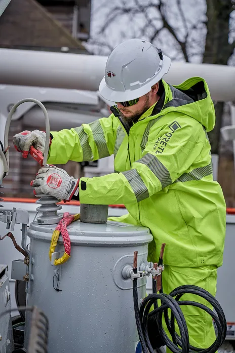 Electrical utility worker performing a routine maintenance task.​