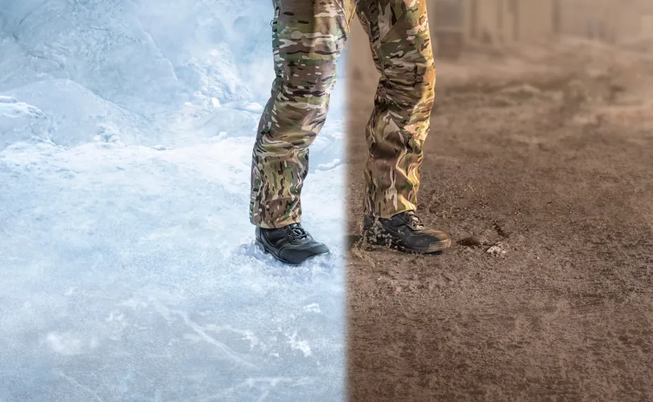 Soldier's legs standing split over a frozen climate and desert climate