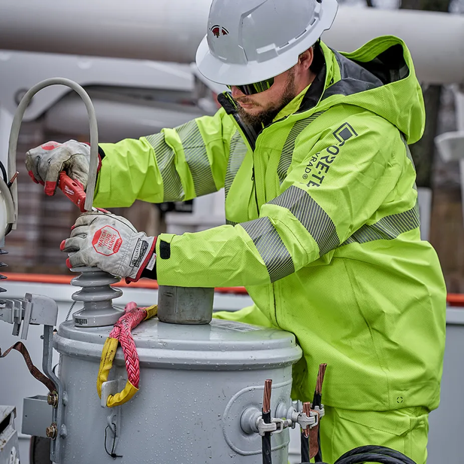 Electrical utility worker performing a routine maintenance task.​