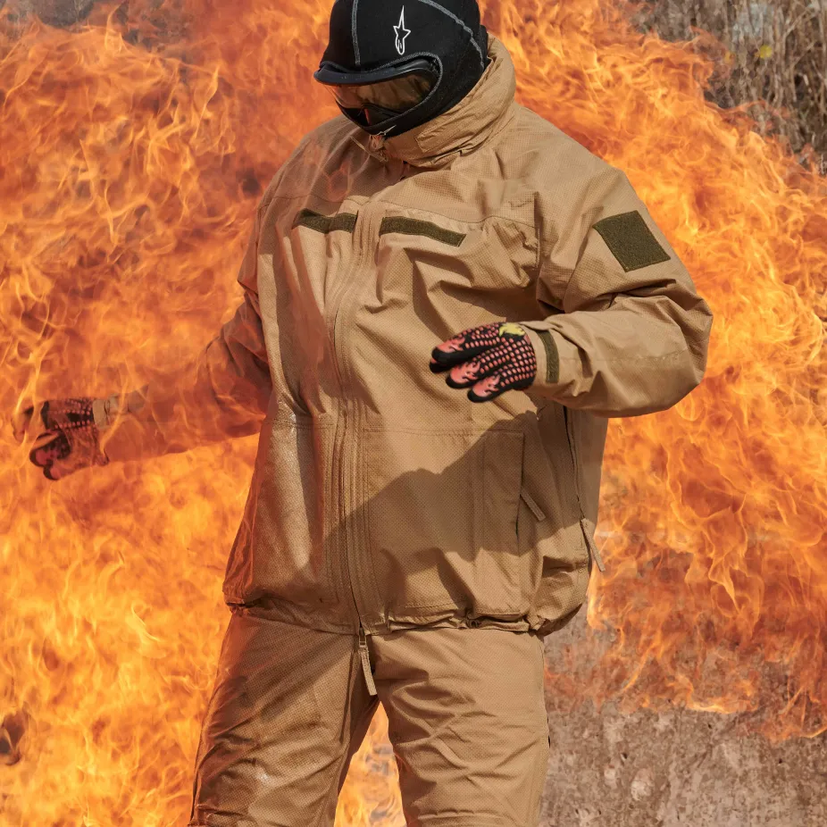 Man standing in and in front of large flame with protective GORE-TEX PYRAD® suit